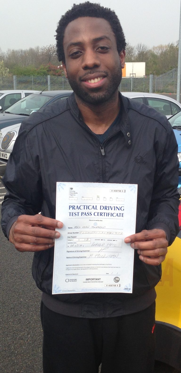 Abel Townsend holding his practical driving test pass certificate