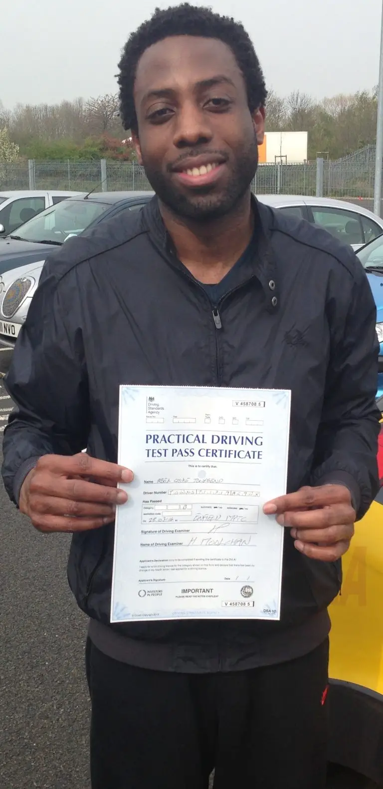 Abel Townsend holding his practical driving test pass certificate