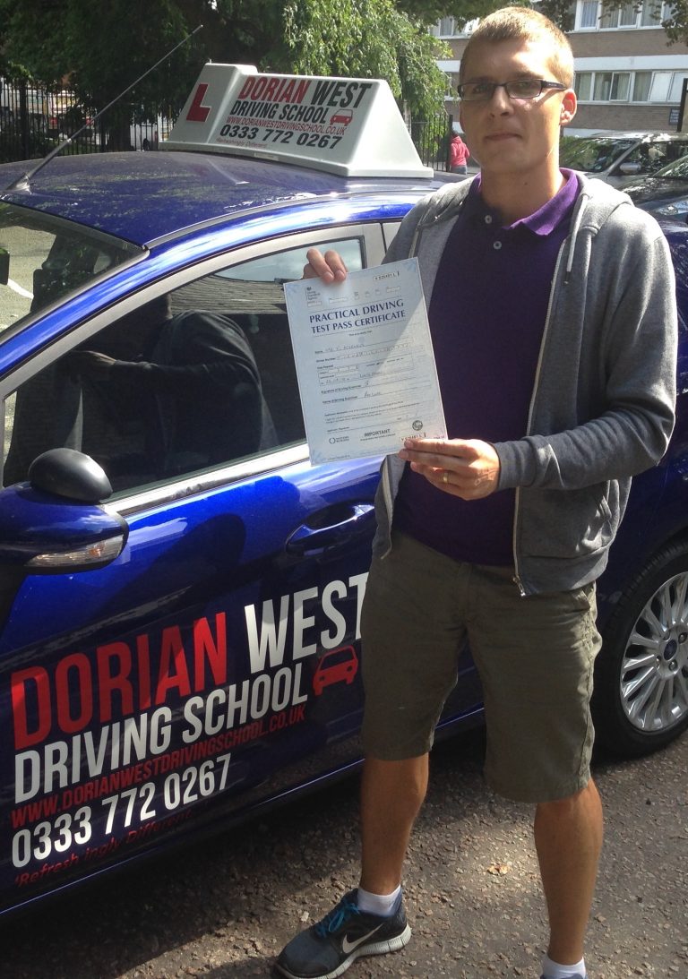 Joaquim Filipe with his pass certificate beside the Dorian West driving school car
